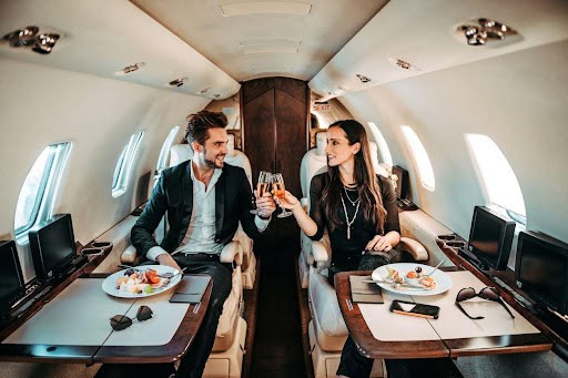 couple enjoys a meal and drinks while on private jet Helland & Hurwitz Attorneys at Law Colorado