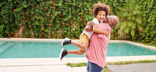 grandma gives grandson a hug near swimming pool Helland & Hurwitz Attorneys at Law Colorado