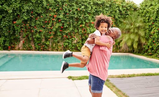 grandma gives grandson a hug near swimming pool Helland & Hurwitz Attorneys at Law Colorado