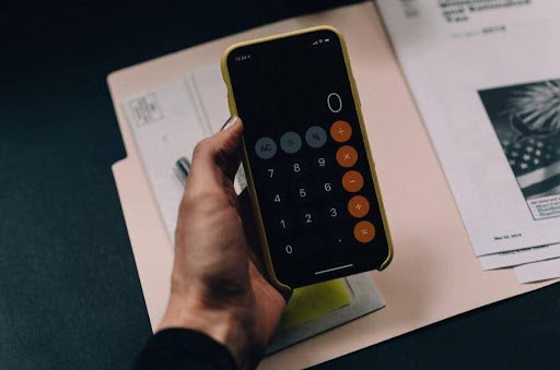 woman uses iPhone calculator to figure out her financials Helland & Hurwitz Attorneys at Law Colorado