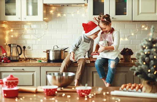 two children enjoy the holidays in the kitchen making treats Helland & Hurwitz Attorneys at Law Colorado