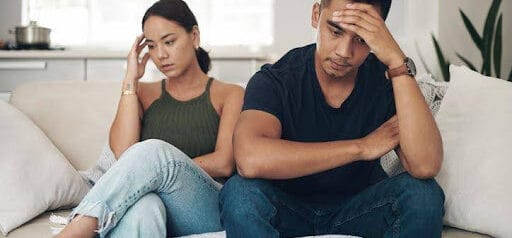 man and woman both with hands on their foreheads are struggling to communicate Helland & Hurwitz Attorneys at Law Colorado