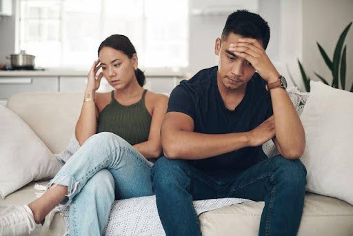 man and woman both with hands on their foreheads are struggling to communicate Helland & Hurwitz Attorneys at Law Colorado