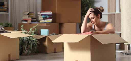 woman is stressed to pack because she did not get the house in the divorce Helland & Hurwitz Attorneys at Law Colorado