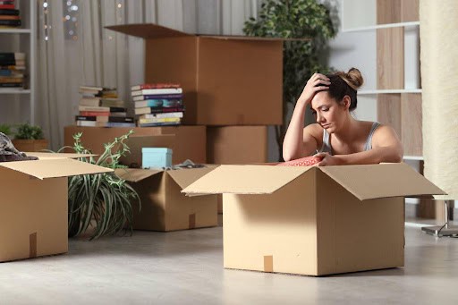 woman is stressed to pack because she did not get the house in the divorce Helland & Hurwitz Attorneys at Law Colorado