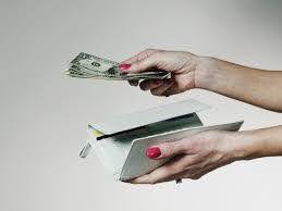 woman hands over money out of her wallet to pay for lawyer Helland & Hurwitz Attorneys at Law Colorado