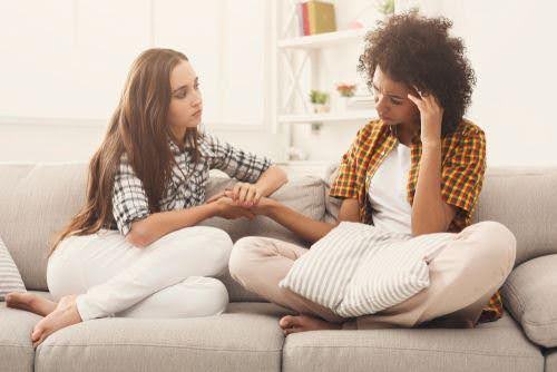 woman confides in friend about getting a divorce Helland & Hurwitz Attorneys at Law Colorado