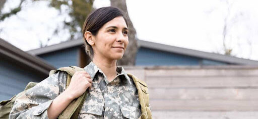 woman in military wears backpack as she goes to work Helland & Hurwitz Attorneys at Law Colorado