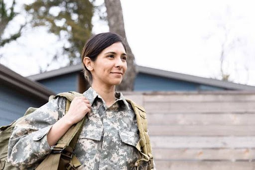 woman in military wears backpack as she goes to work Helland & Hurwitz Attorneys at Law Colorado