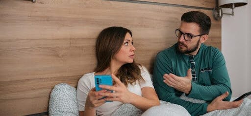 man and woman sitting in bedroom while in a disagreement Helland & Hurwitz Attorneys at Law Colorado