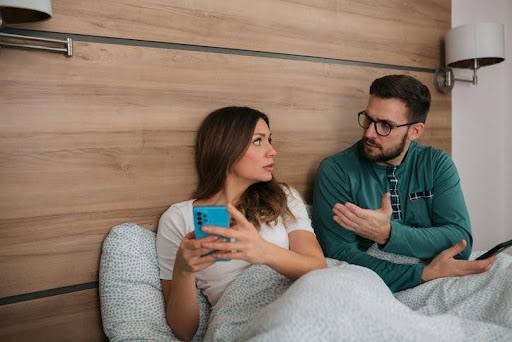 man and woman sitting in bedroom while in a disagreement Helland & Hurwitz Attorneys at Law Colorado