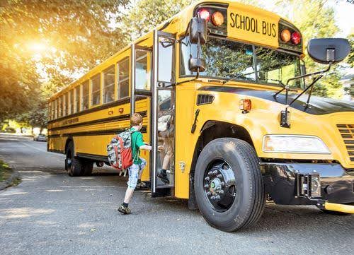 young boy in green shirt gets on school bus Helland & Hurwitz Attorneys at Law Colorado
