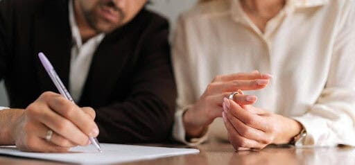 man signs protection order as woman removes wedding ring Helland & Hurwitz Attorneys at Law Colorado