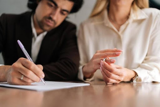 man signs protection order as woman removes wedding ring Helland & Hurwitz Attorneys at Law Colorado