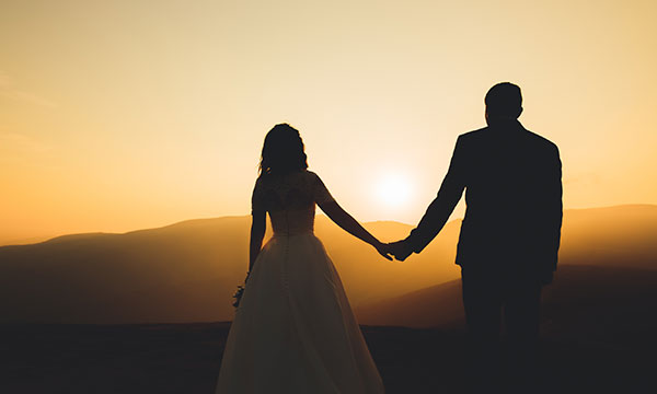 newlyweds enjoy sunset after marriage Helland & Hurwitz Attorneys at Law Colorado
