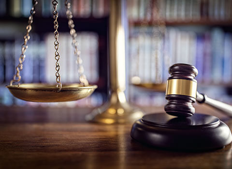 close up of gavel with legal scales in background Helland & Hurwitz Attorneys at Law Colorado