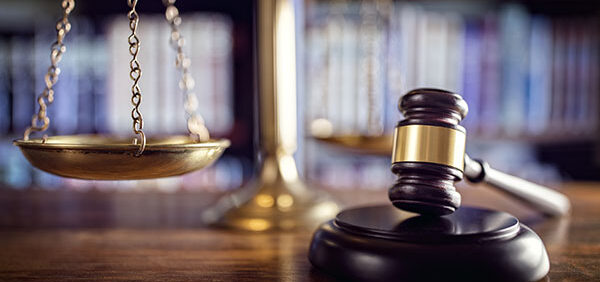 legal scale with gavel in foreground Helland & Hurwitz Attorneys at Law Colorado