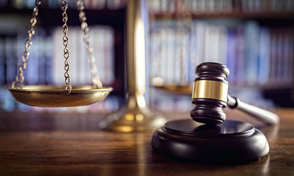legal scale with gavel in foreground Helland & Hurwitz Attorneys at Law Colorado