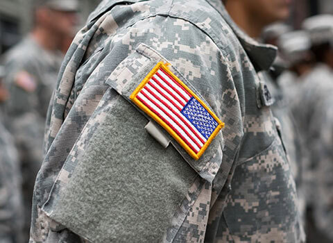 close up image of military officer wearing fatigues with American flag patch on arm Helland & Hurwitz Attorneys at Law Colorado
