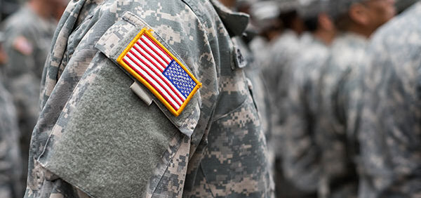 military employee wearing fatigues stands at attention Helland & Hurwitz Attorneys at Law Colorado