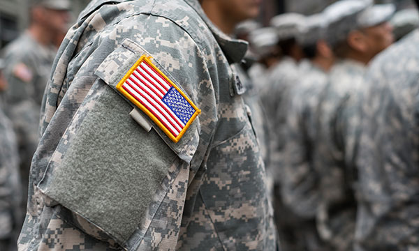 military employee wearing fatigues stands at attention Helland & Hurwitz Attorneys at Law Colorado