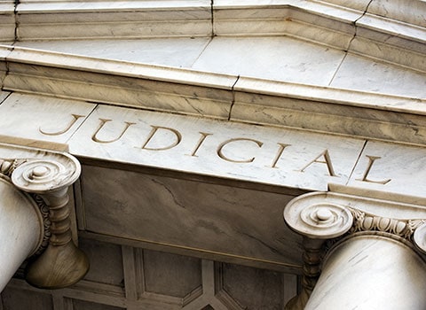 close up of "judicial" on courthouse Helland & Hurwitz Attorneys at Law Colorado