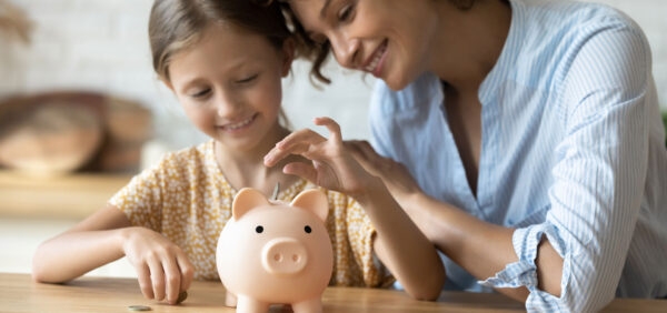 mom and daughter saving coins into piggy bank Helland & Hurwitz Attorneys at Law Colorado