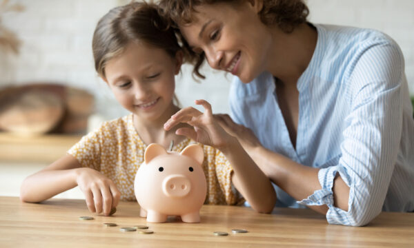 mom and daughter saving coins into piggy bank Helland & Hurwitz Attorneys at Law Colorado
