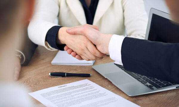 following mediation, man and woman shake hands Helland & Hurwitz Attorneys at Law Colorado