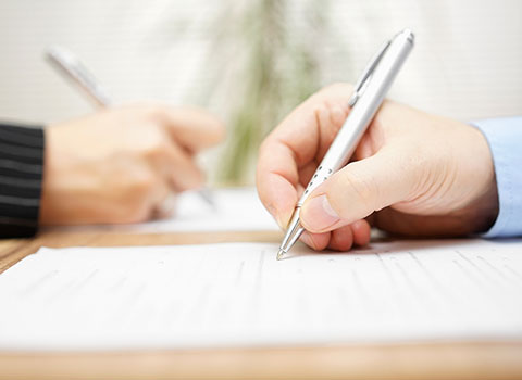 close up of man signing prenup Helland & Hurwitz Attorneys at Law Colorado